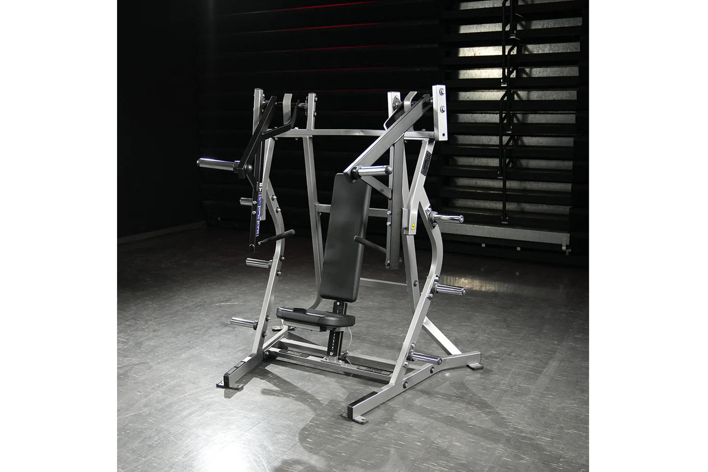 Hammer Strength plate-loaded iso-lateral bench press machine with silver frame and black padded seat in gym setting