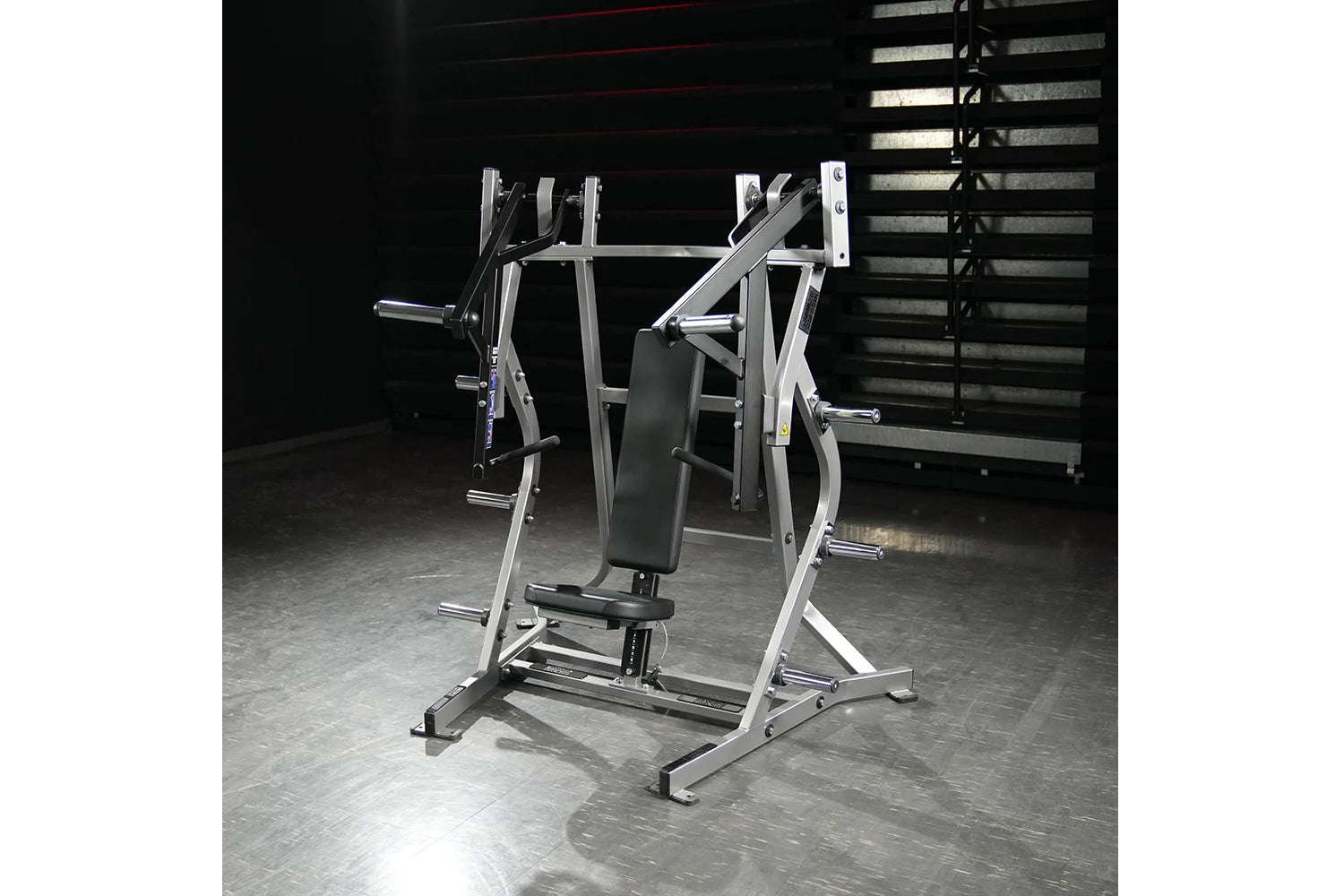 Hammer Strength plate-loaded iso-lateral bench press machine with silver frame and black padded seat in gym setting