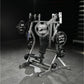 Hammer Strength plate-loaded iso-lateral bench press with silver frame, black seat, and loaded weight plates on gym floor