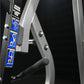Hammer Strength plate-loaded iso-lateral bench press with black frame, silver accents, and blue instructional decals showing 