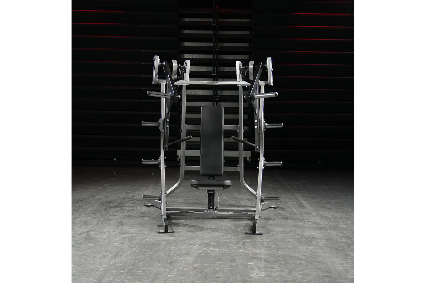 Hammer Strength plate-loaded iso-lateral bench press with chrome and silver frame, black padded seat, and weight plate holder