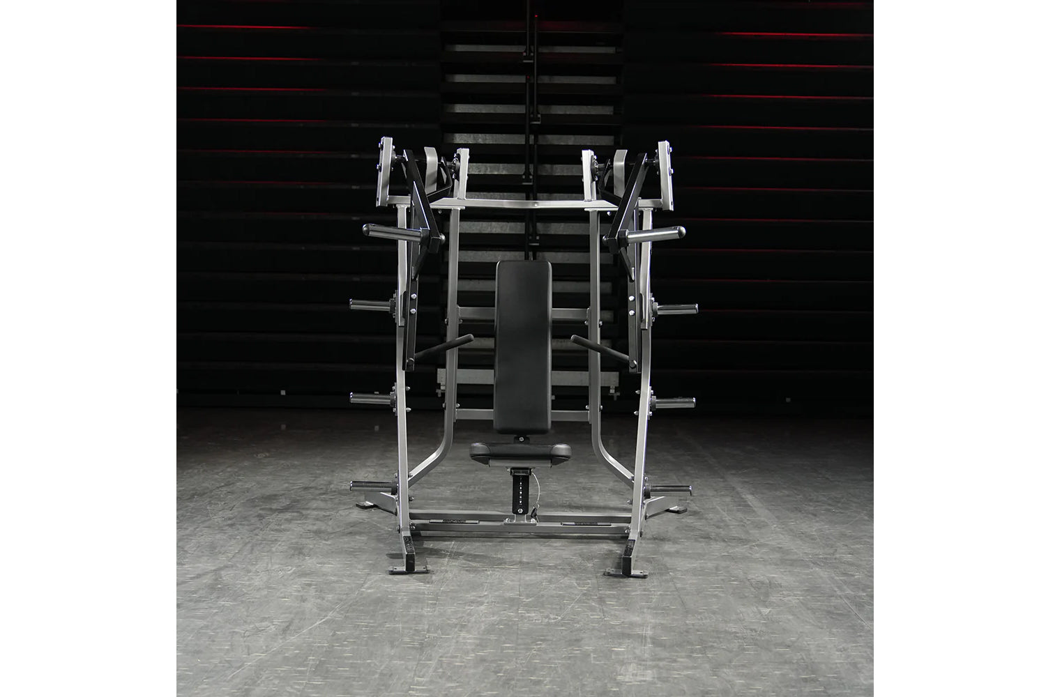 Hammer Strength plate-loaded iso-lateral bench press with chrome and silver frame, black padded seat, and weight plate holder