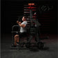 Man using black Hammer Strength plate-loaded chest/back machine in gym setting with red accent lighting