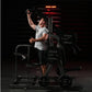 Man in light gray t-shirt using black Hammer Strength plate-loaded chest/back machine with red neon lighting in dark gym sett
