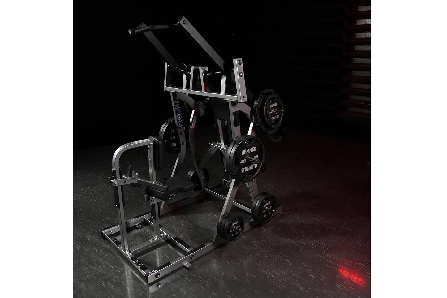 Hammer Strength plate-loaded iso-lateral chest/back machine with silver frame, black seat, and loaded weight plates on dark g