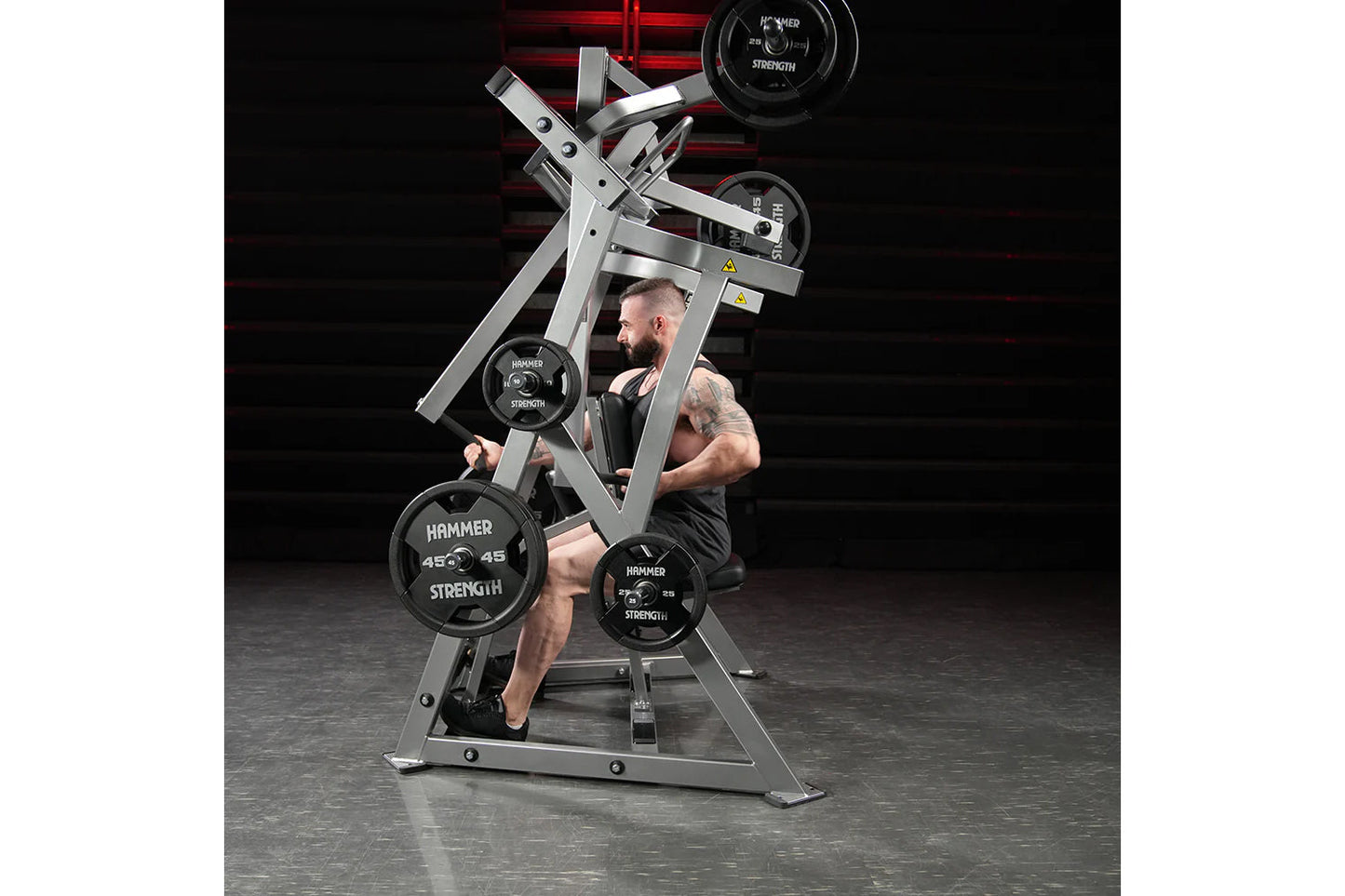 Hammer Strength plate-loaded iso-lateral D.Y. row machine with black weight plates, used by male model in gym setting