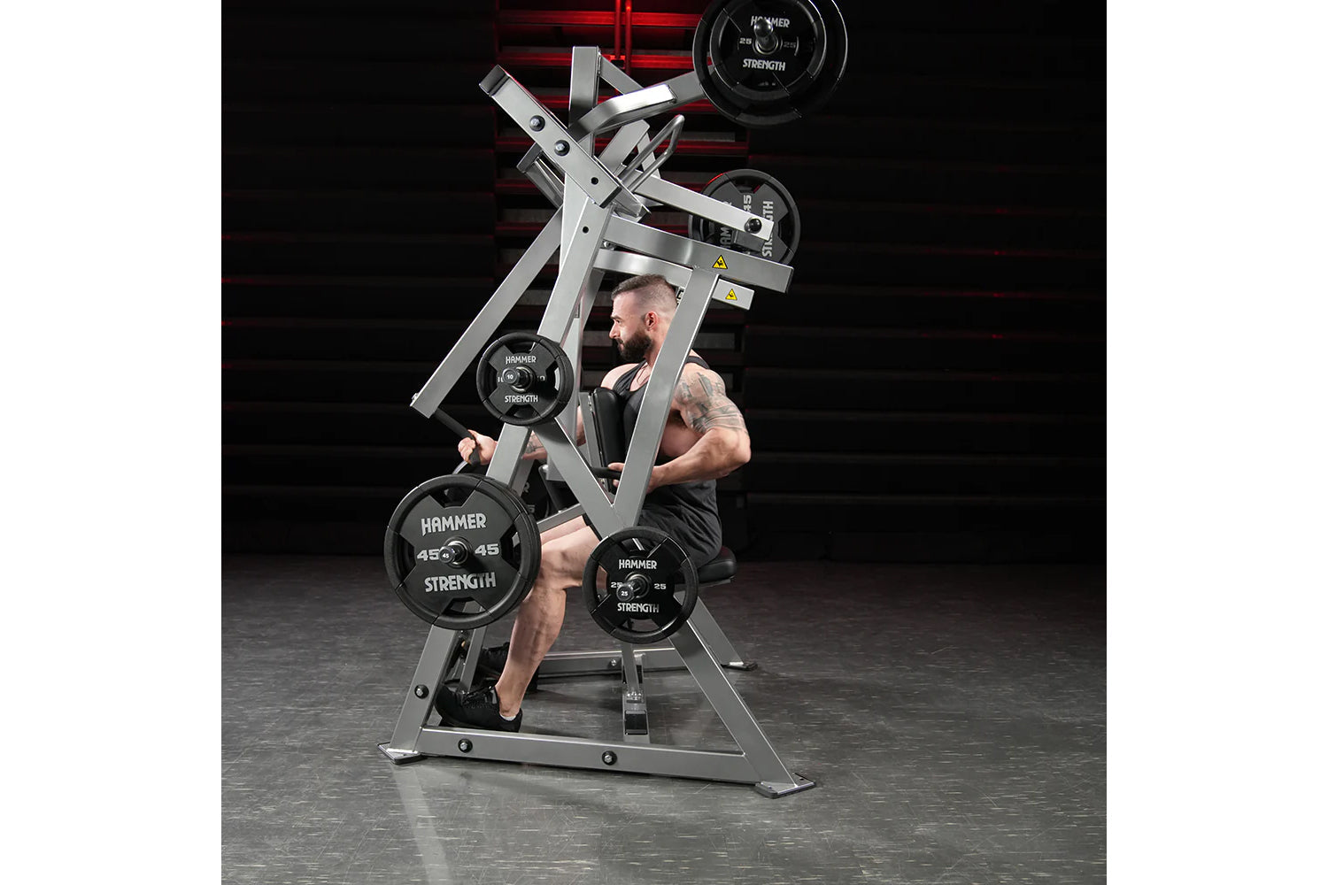 Hammer Strength plate-loaded iso-lateral D.Y. row machine with black weight plates, used by male model in gym setting