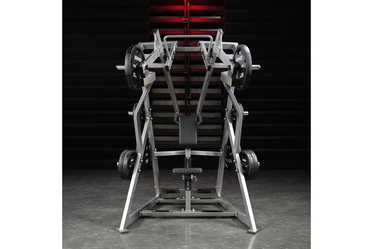 Hammer Strength plate-loaded iso-lateral D.Y. row machine with silver frame and black weight plates on garage gym background
