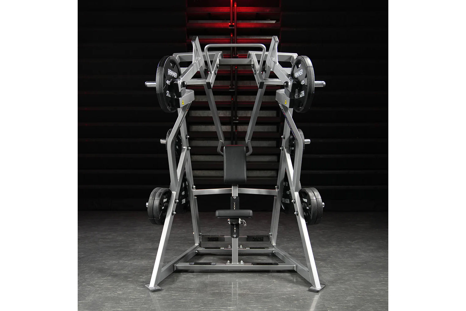 Hammer Strength plate-loaded iso-lateral D.Y. row machine with silver frame and black weight plates on garage gym background