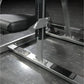 Hammer Strength plate-loaded iso-lateral D.Y. row machine with black padded seat, silver frame, and adjustment lever in gym s