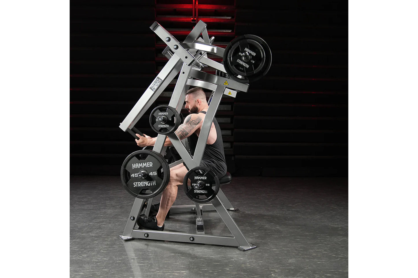 Hammer Strength plate-loaded iso-lateral D.Y. row machine with gray steel frame, black weight plates, worn by male model in g