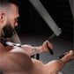 Bearded man with tattoos using plate-loaded iso-lateral row machine in gym setting