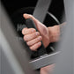Child's hand gripping black foam handle of exercise equipment in close-up detail