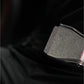 Black metal weight plate with "LTM" branding detail on dark background