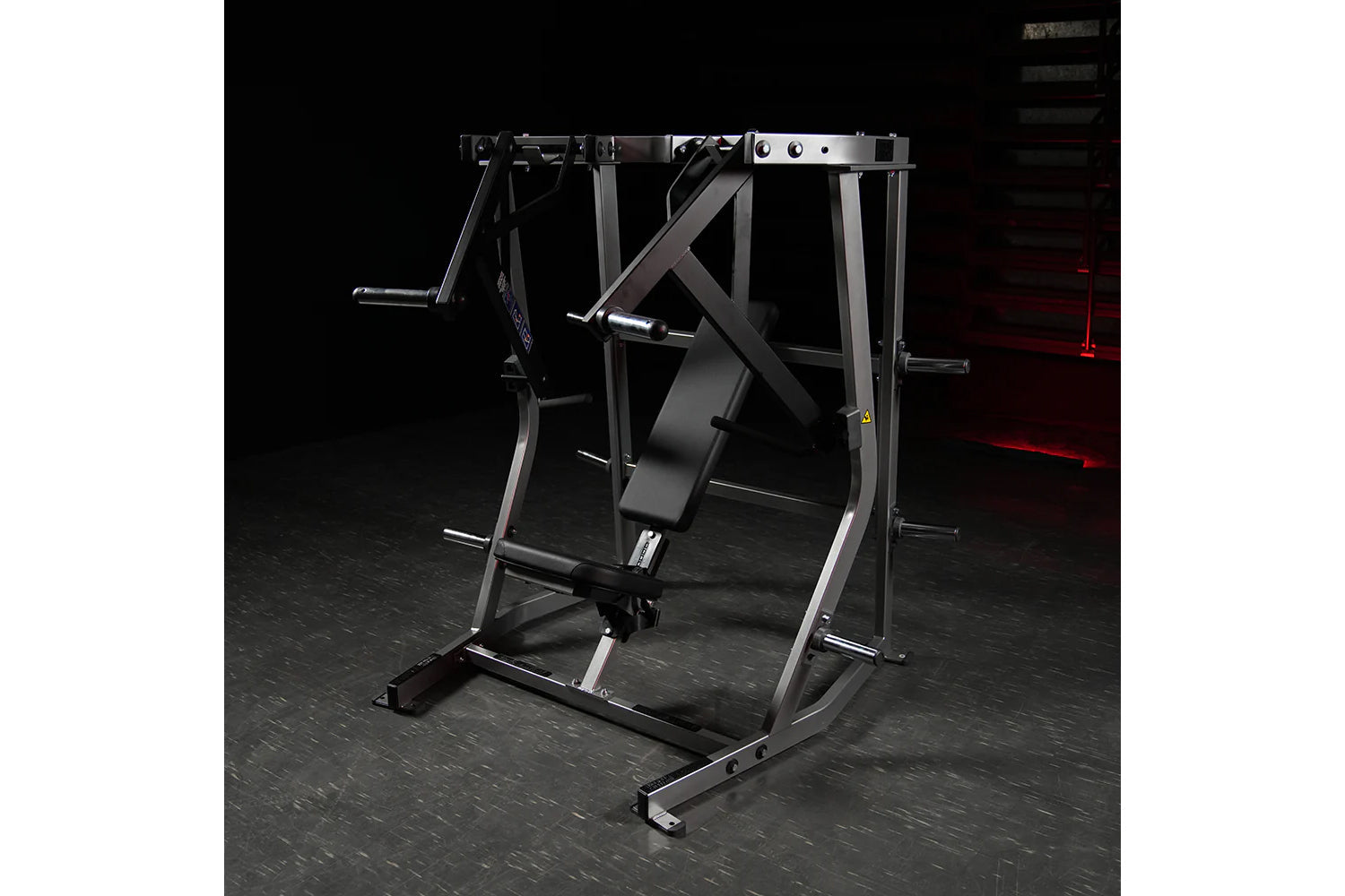 Hammer Strength plate-loaded iso-lateral decline chest press with black padded seat and silver metal frame on dark gym floor
