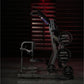 Hammer Strength black plate-loaded iso-lateral front lat pulldown machine with weight plates loaded, front view against red b