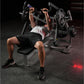 Man performing chest press exercise on black Hammer Strength plate-loaded bench with loaded barbell in gym setting