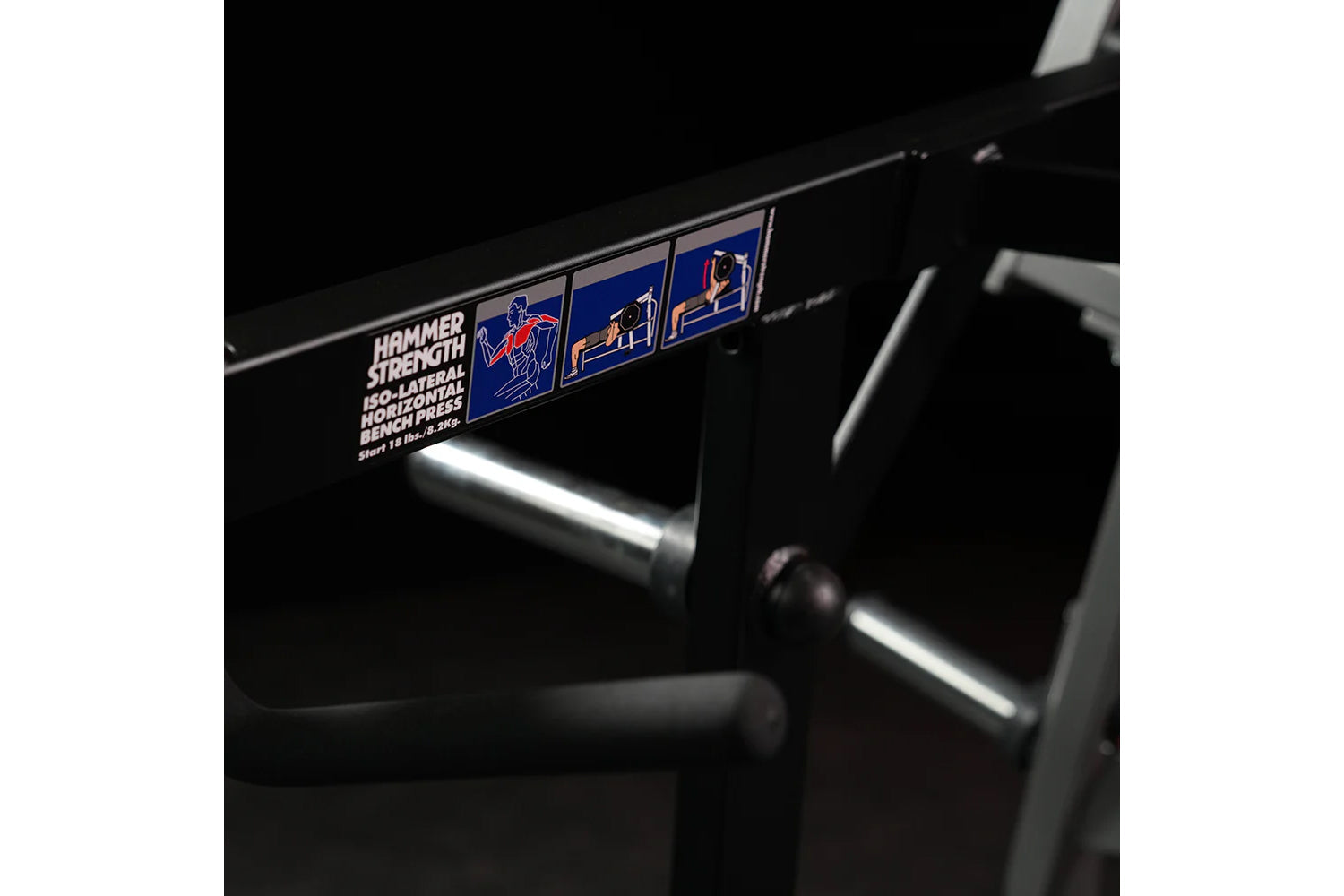 Hammer Strength plate-loaded iso-lateral horizontal bench press with black frame and chrome handles, detail view of machine n
