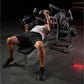 Man performing chest press on black Hammer Strength plate-loaded bench press machine in gym setting