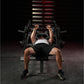 Man performing chest press exercise on black Hammer Strength plate-loaded bench with dumbbells in gym setting