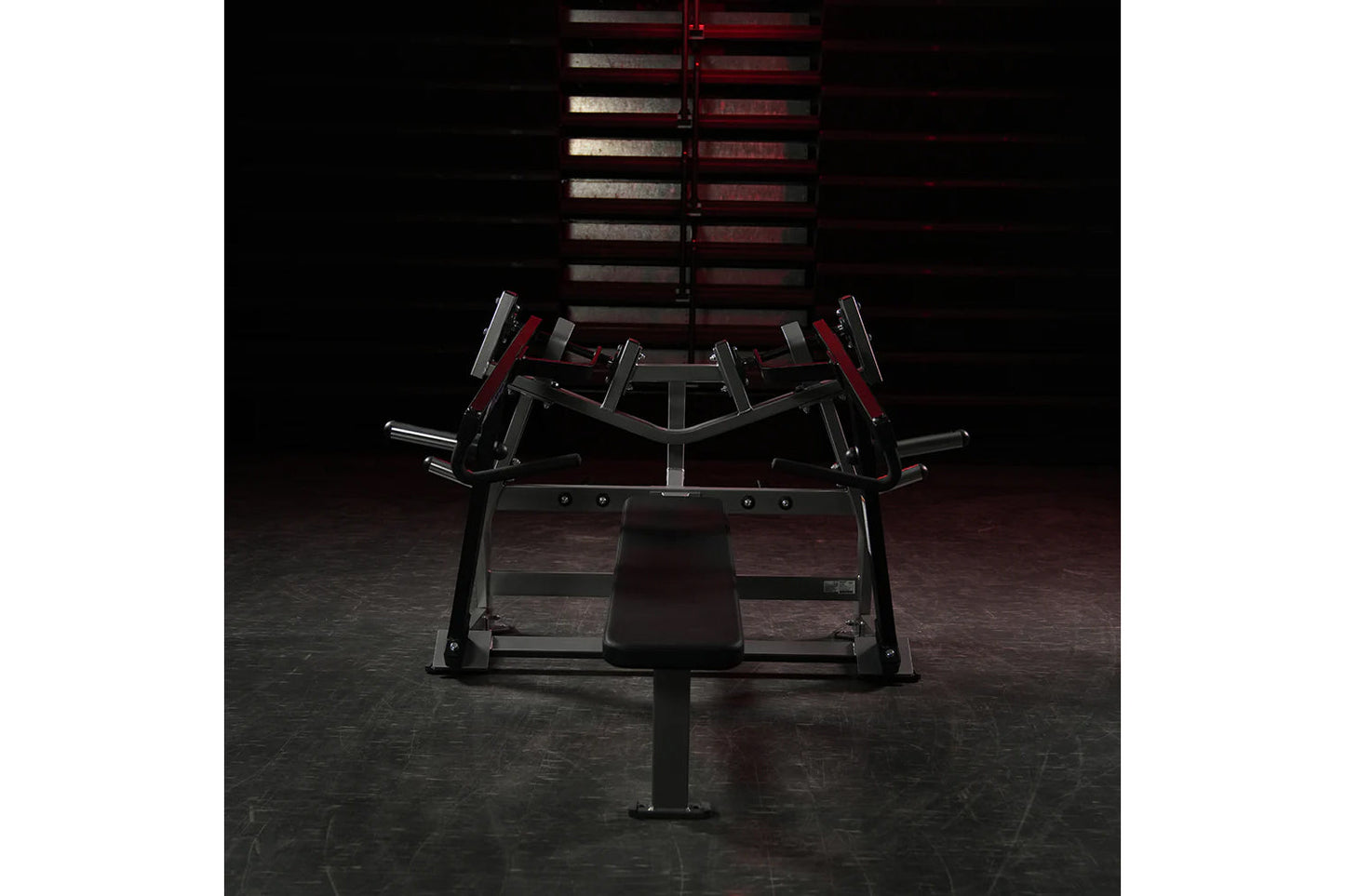 Hammer Strength plate-loaded iso-lateral horizontal bench press with black frame and red accents, front view in gym setting