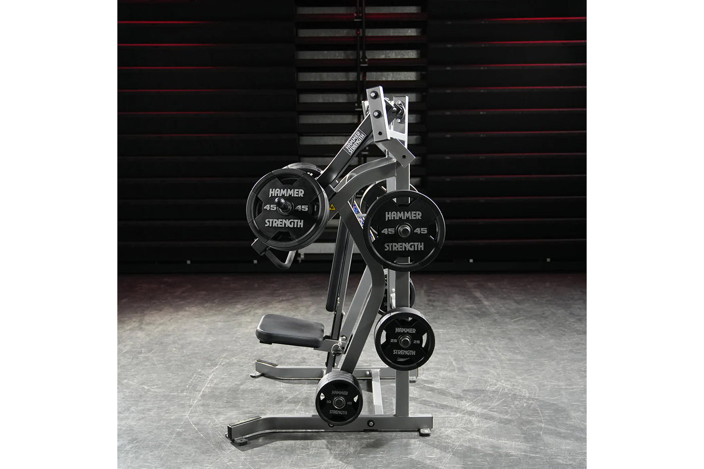 Hammer Strength plate-loaded iso-lateral incline press with black weight plates, silver frame, and padded seat in gym setting
