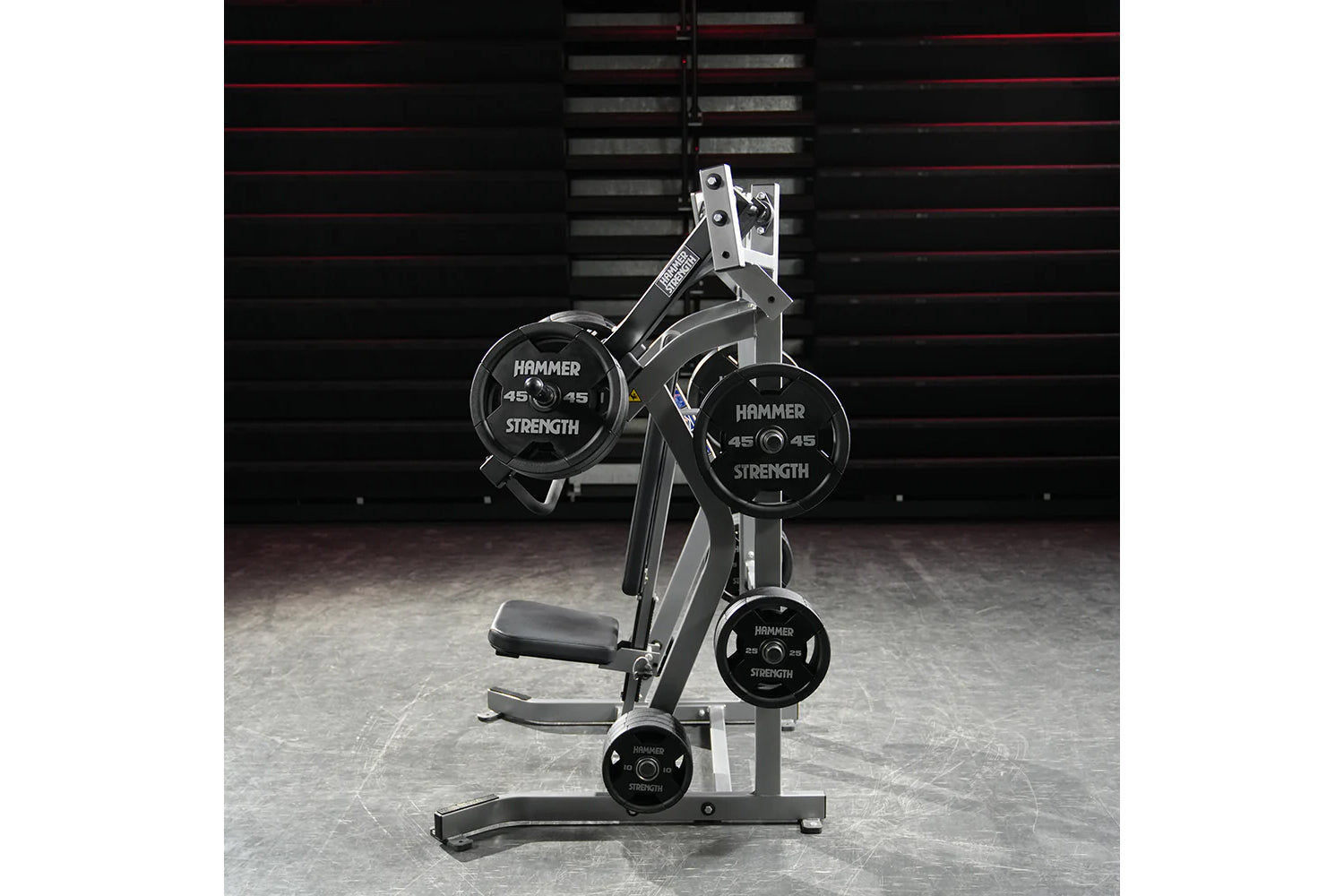 Hammer Strength plate-loaded iso-lateral incline press with black weight plates, silver frame, and padded seat in gym setting
