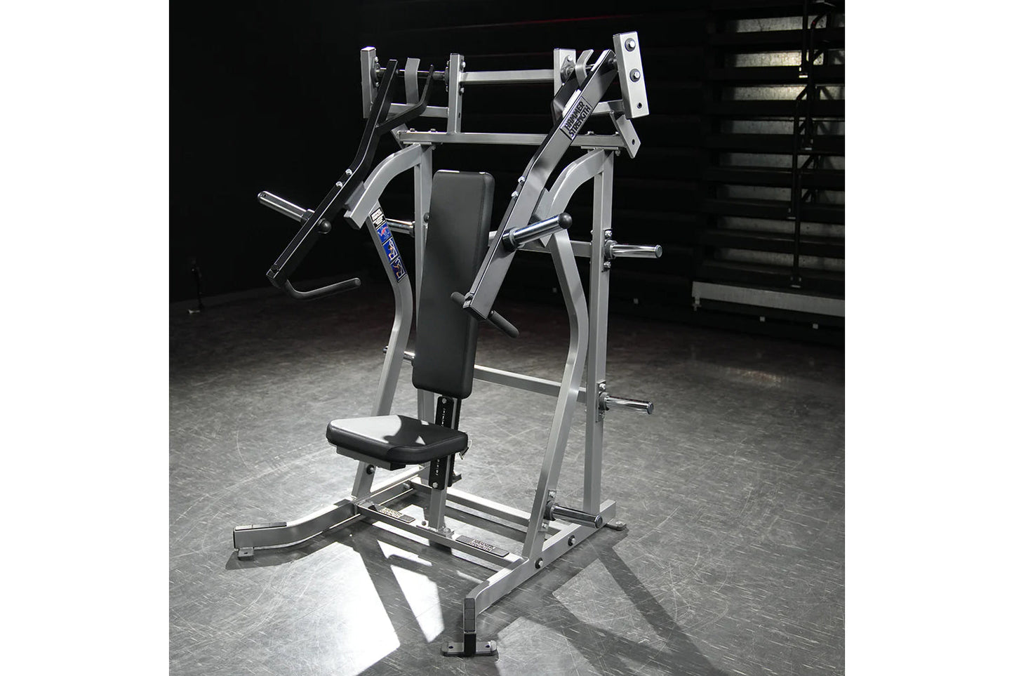 Hammer Strength silver and black plate-loaded iso-lateral incline press with padded seat in gym setting
