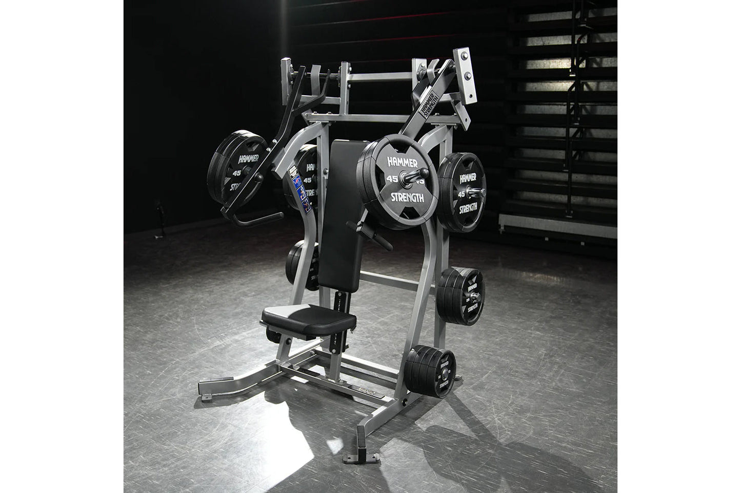 Hammer Strength plate-loaded iso-lateral incline press machine with black weight plates and silver metal frame in gym setting