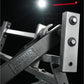 Hammer Strength plate-loaded iso-lateral incline press with silver metallic frame and black handles against dark background
