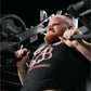 Man wearing black graphic t-shirt using Hammer Strength plate-loaded incline press machine with weighted plates loaded on bot