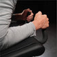 Man using black Hammer Strength plate-loaded iso-lateral kneeling leg curl machine, wearing light gray long-sleeve shirt