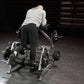 Man using gray and black plate-loaded leg curl machine in gym setting, demonstrating kneeling position