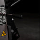 Black Hammer Strength plate-loaded leg curl machine with yellow hazard warning symbol on side panel, detail view