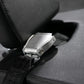 Silver metal seat belt buckle with black fabric strap on dark textured car seat interior