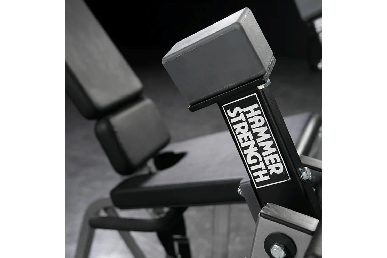 Hammer Strength plate-loaded iso-lateral leg extension machine with gray seat and black frame detail