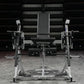 Hammer Strength plate-loaded iso-lateral leg extension machine with black padded seat and silver frame, front view on gym flo