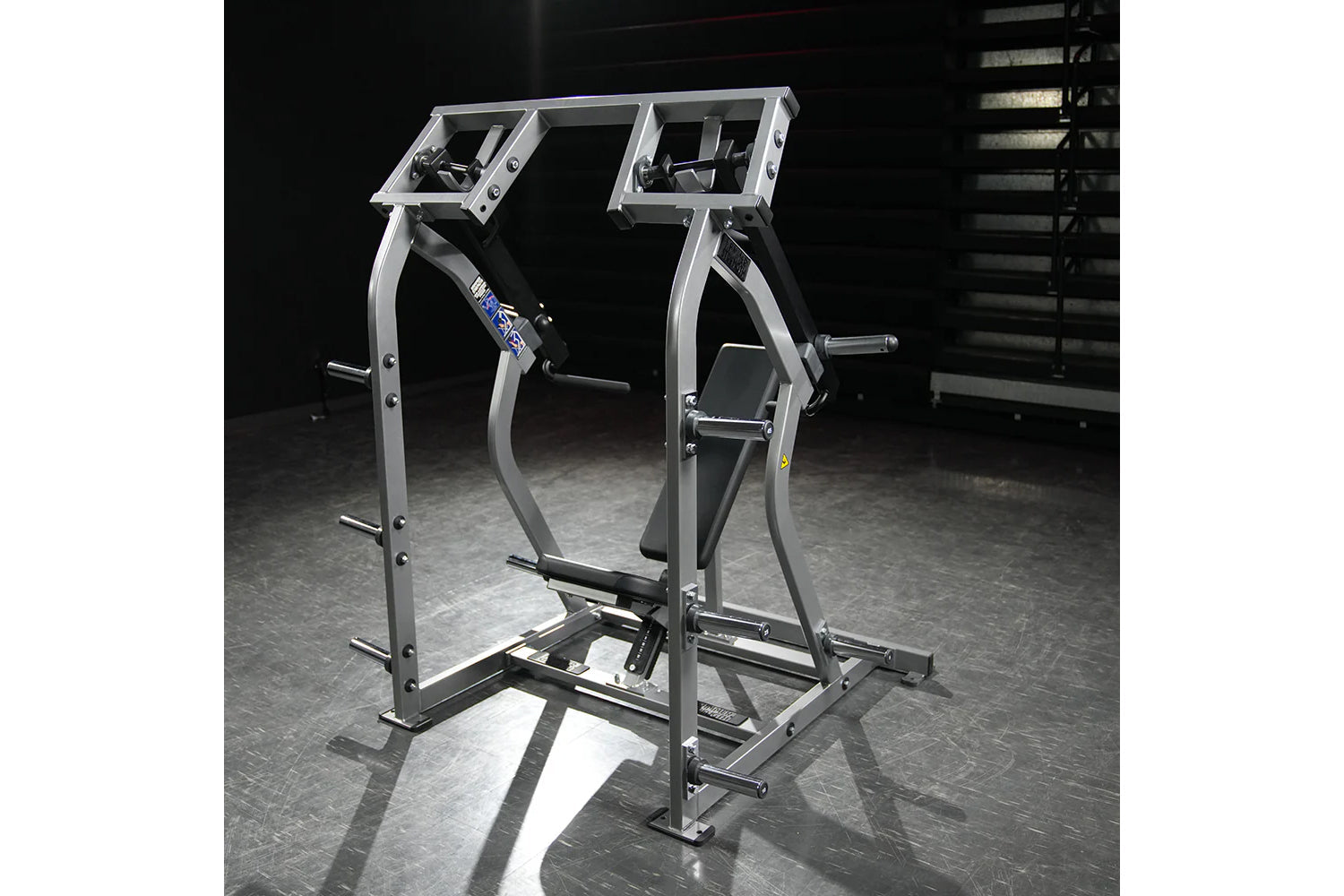 Hammer Strength plate-loaded iso-lateral shoulder press machine with silver frame and black seat in gym setting