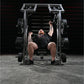 Man performing shoulder press on Hammer Strength plate-loaded machine with loaded weight plates in gym setting
