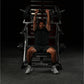 Man performing incline press on black and red Hammer Strength plate-loaded machine in gym setting