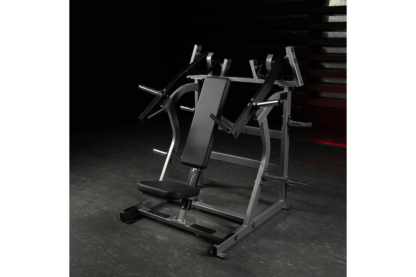 Hammer Strength plate-loaded iso-lateral super incline press with gray frame and black padding on dark gym floor