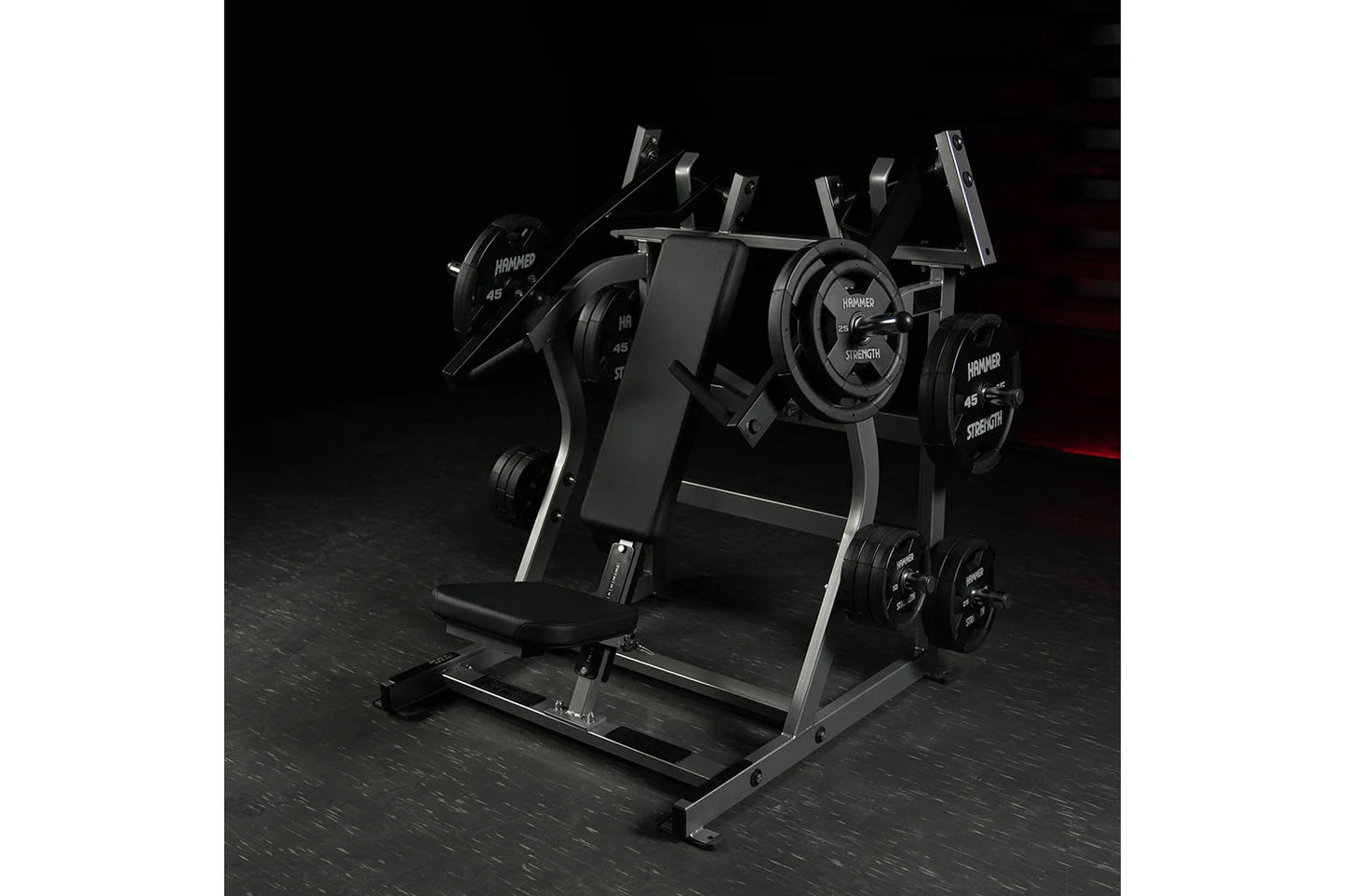 Hammer Strength black plate-loaded iso-lateral super incline press with dual weight plates and padded seat on dark gym floor