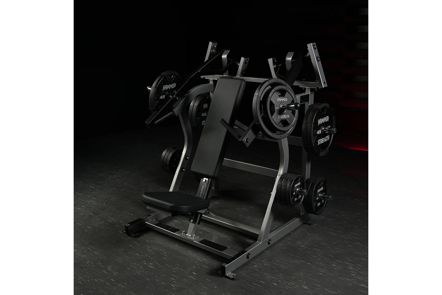 Hammer Strength black plate-loaded iso-lateral super incline press with dual weight plates and padded seat on dark gym floor