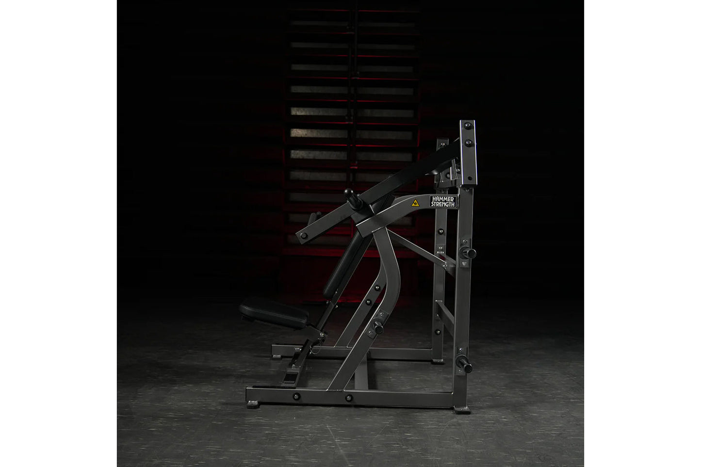 Hammer Strength plate-loaded iso-lateral super incline press with black frame and dual handles on dark background