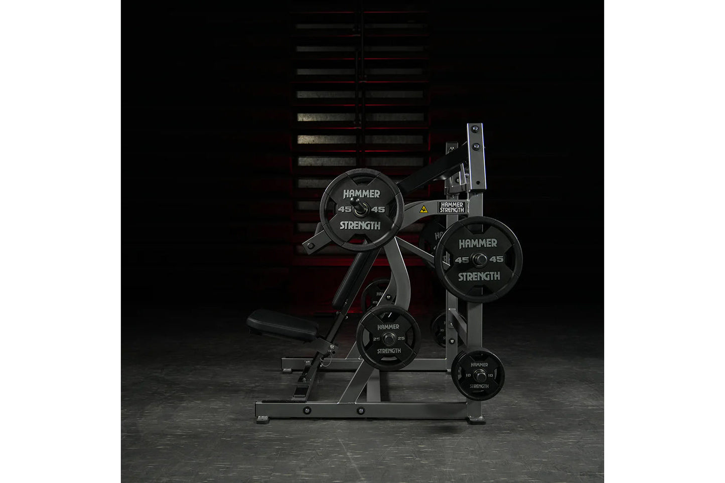 Hammer Strength plate-loaded iso-lateral super incline press with black weight plates and gray steel frame on gym floor