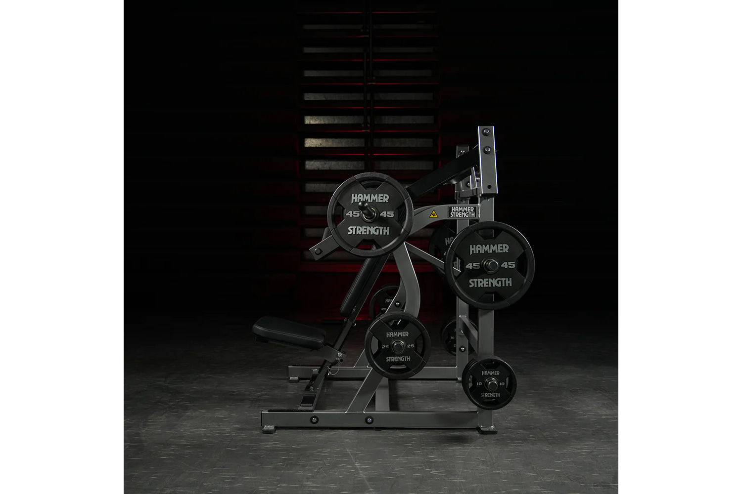 Hammer Strength plate-loaded iso-lateral super incline press with black weight plates and gray steel frame on gym floor