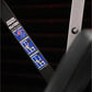 Black plate-loaded chest press machine with blue and red graphic labels showing exercise instructions, detail view of side pa