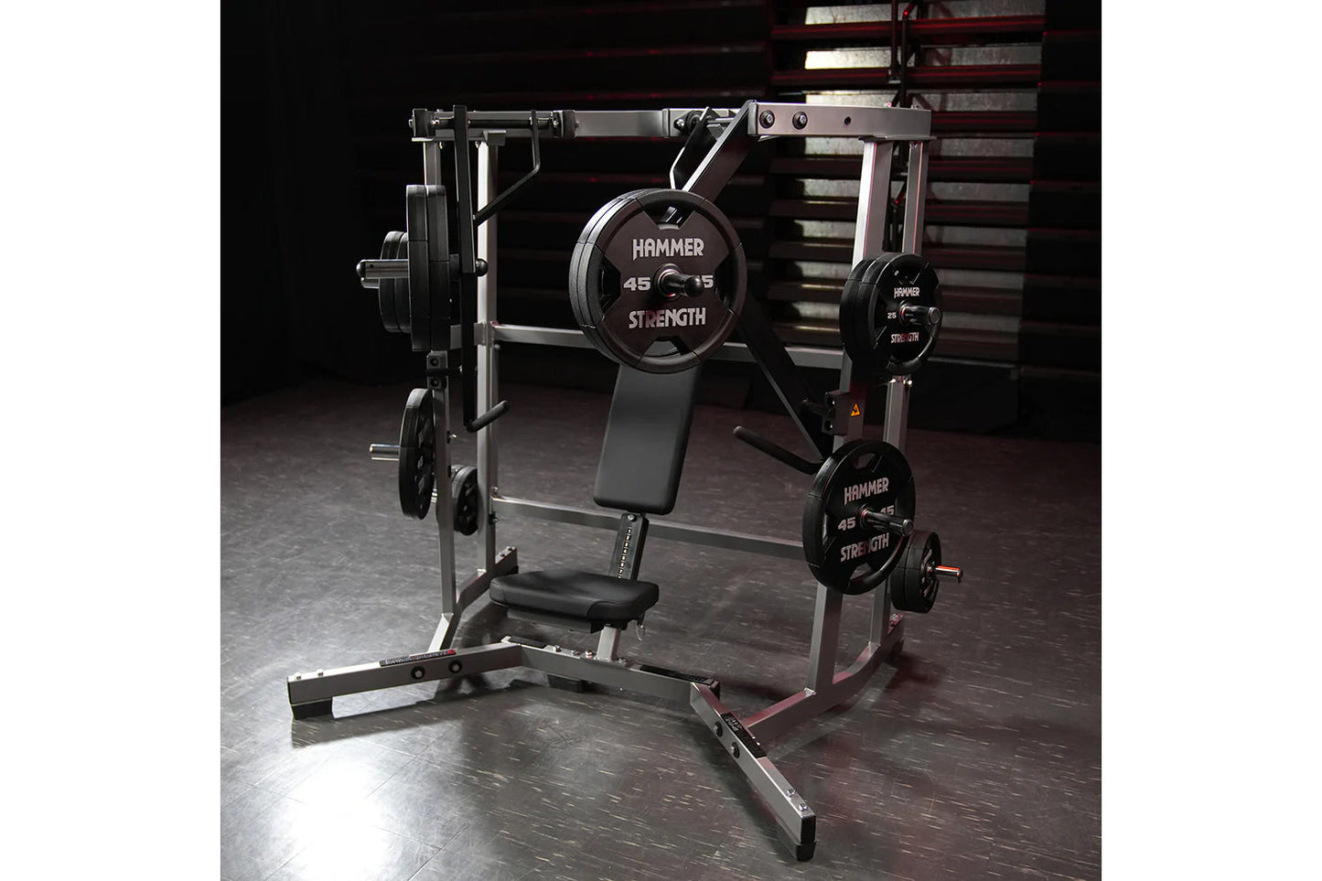 Hammer Strength plate-loaded iso-lateral wide chest machine with black weight plates and gray steel frame on dark gym floor