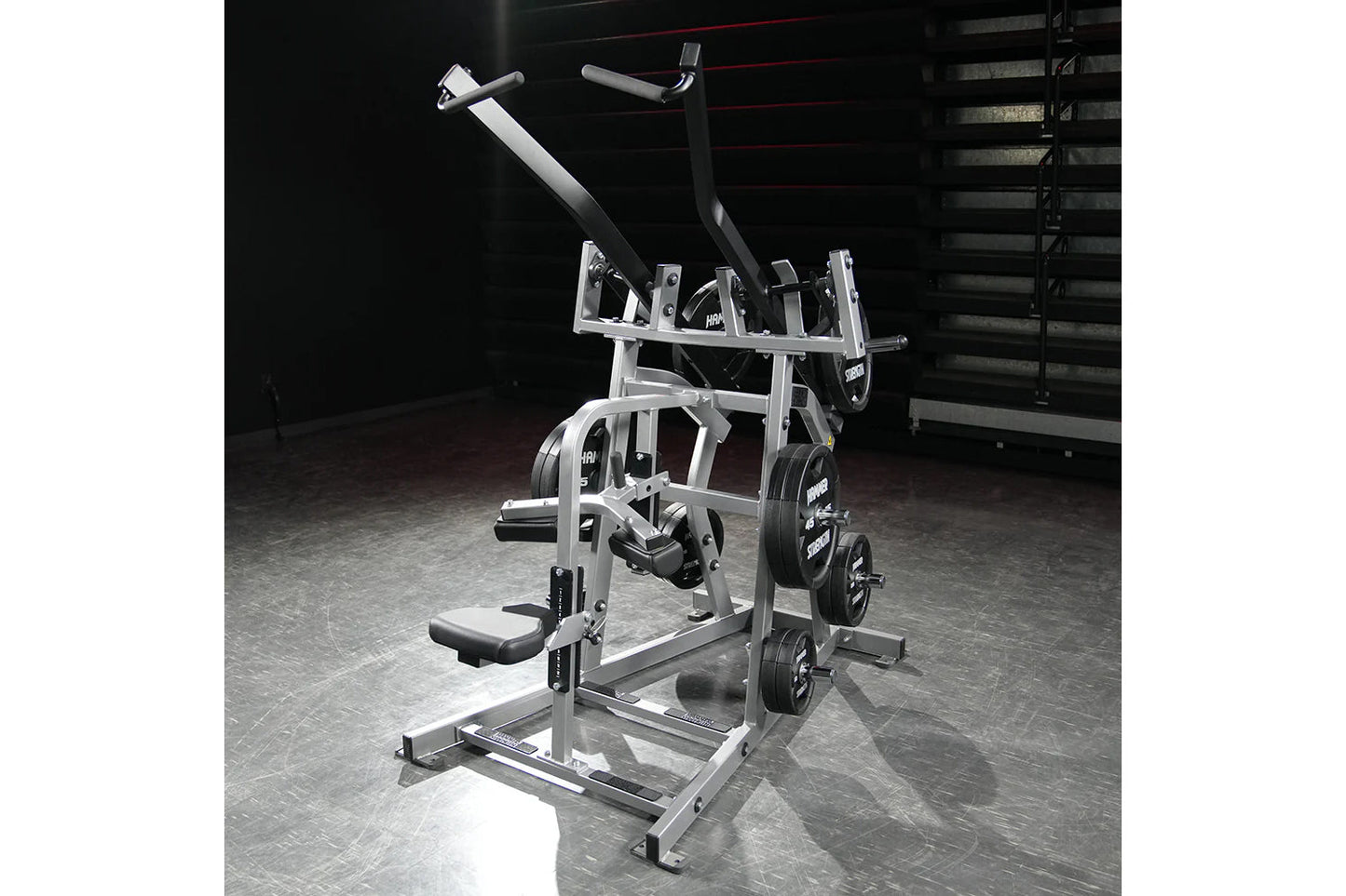 Hammer Strength plate-loaded iso-lateral wide pulldown machine with dual handles, footplate, and weight plates loaded on gym 