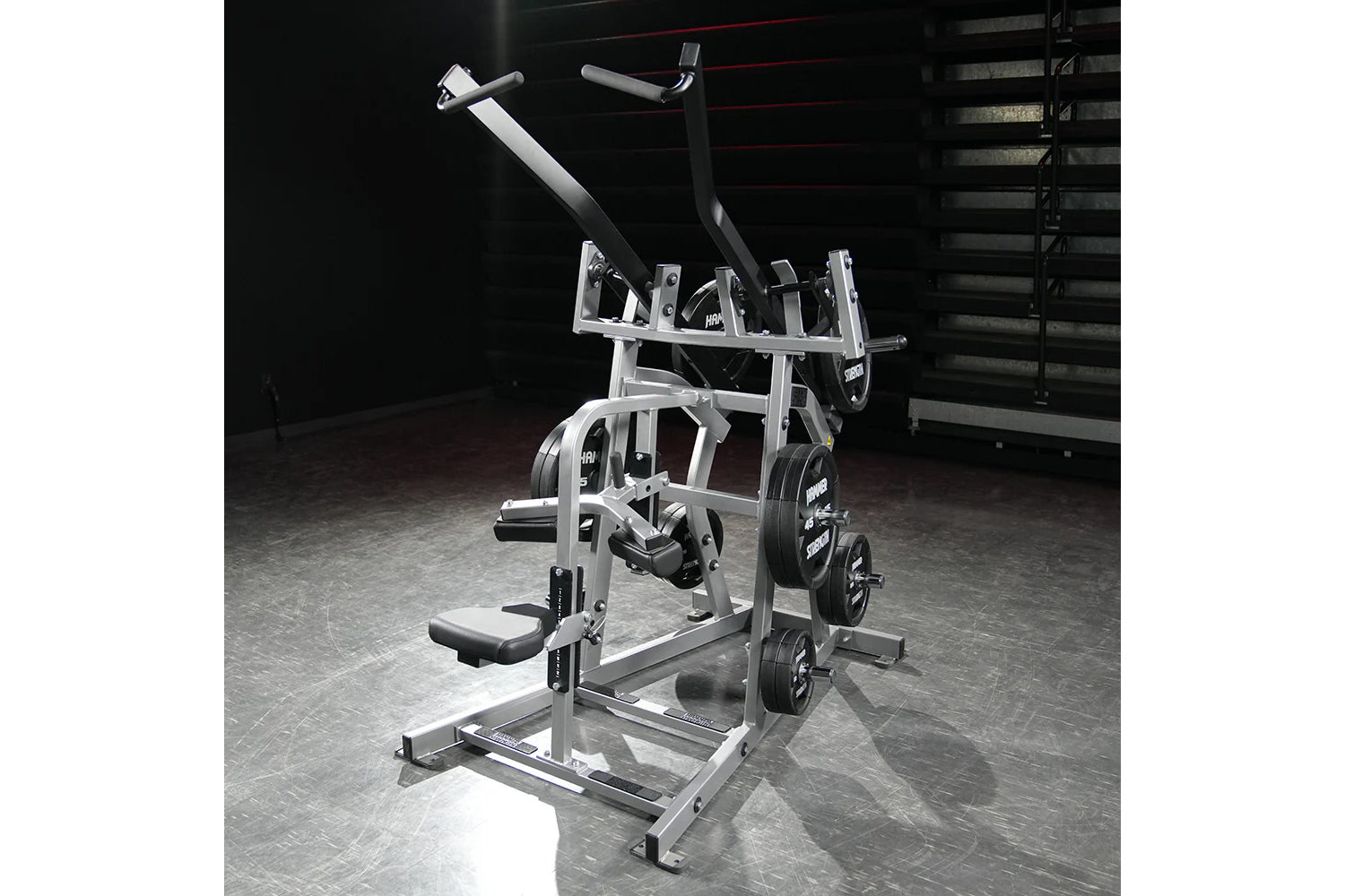 Hammer Strength plate-loaded iso-lateral wide pulldown machine with dual handles, footplate, and weight plates loaded on gym 
